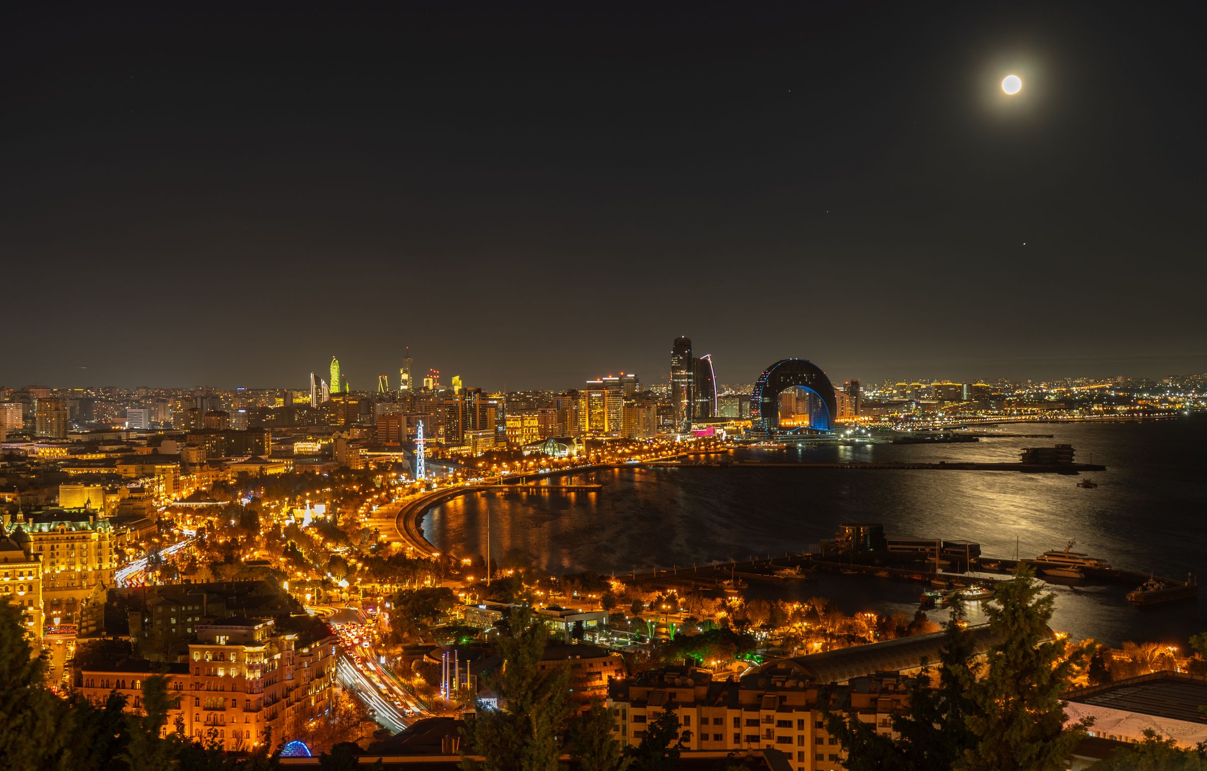 Aerial night view of the Baku skyline and the Caspian coastline