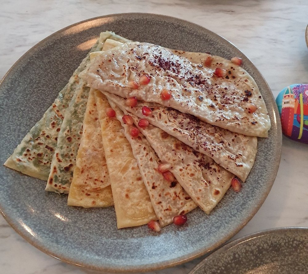 Qutab — thin folded flatbreads with herb and cheese fillings, sumac and pomegranate, at Chayki in Baku