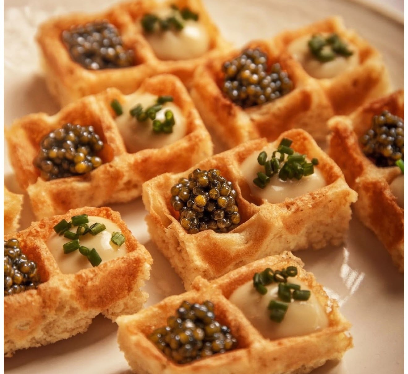 Bite-sized waffles filled with crème fraîche, chives and Caspian caviar