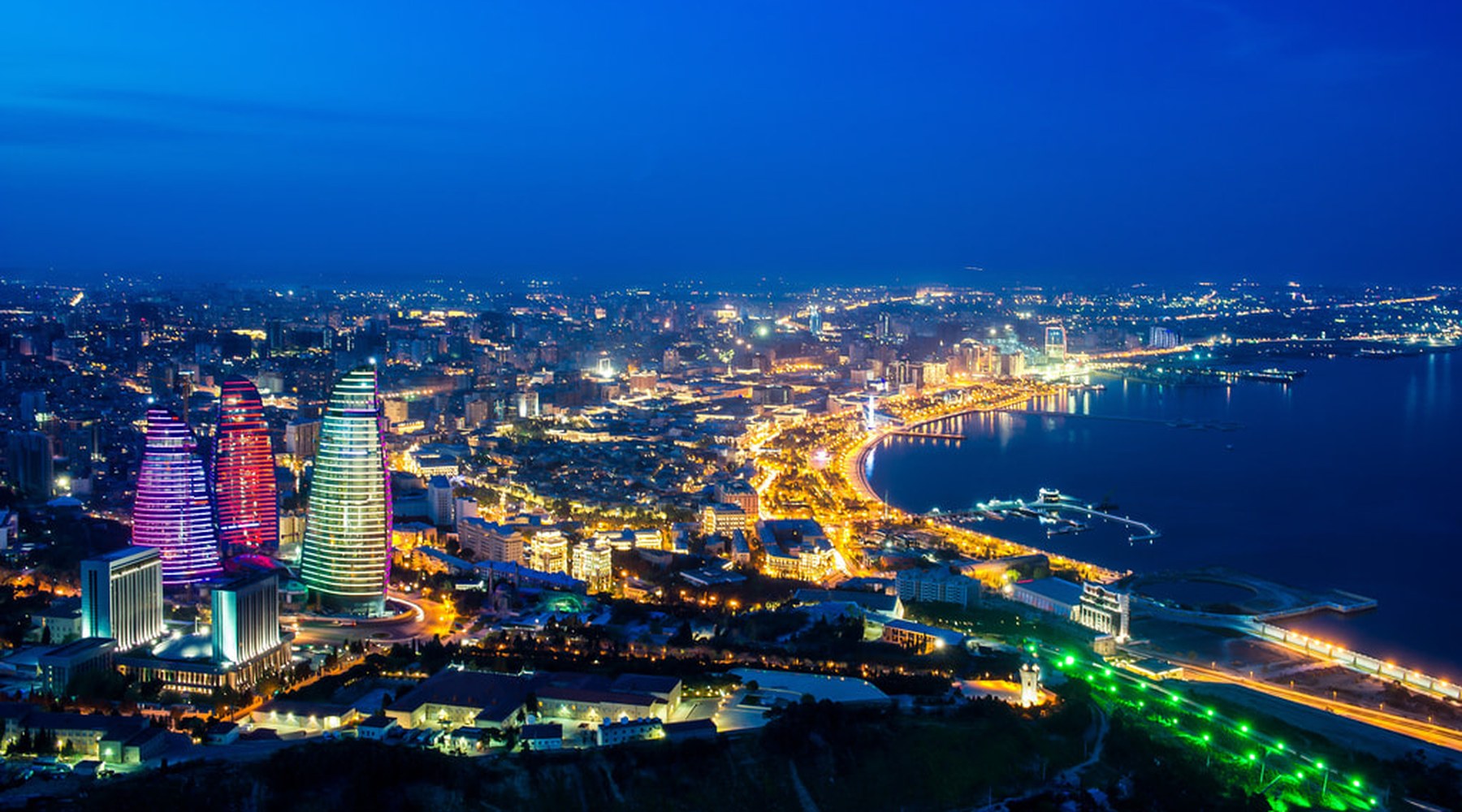 The Baku skyline and the Caspian shoreline lit after dark